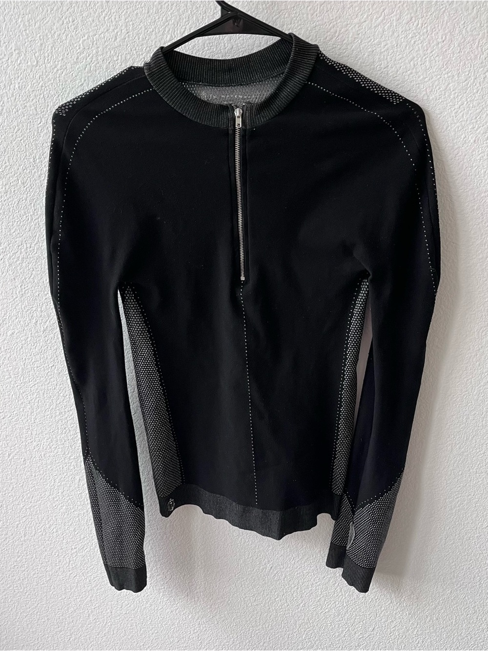 Black quarter zip long sleeve top, gray mesh panels on sides, sleeves and back